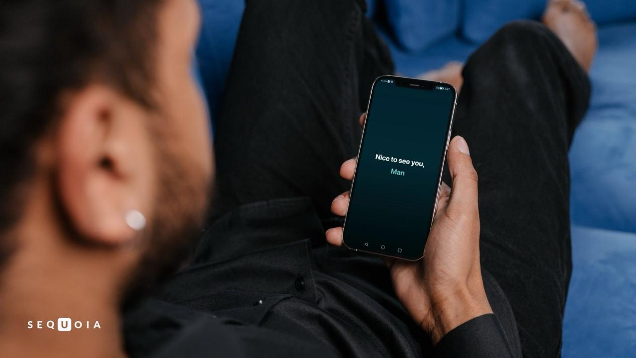 Man holding an Android device running Sequoia 1.0 with the welcome screen
