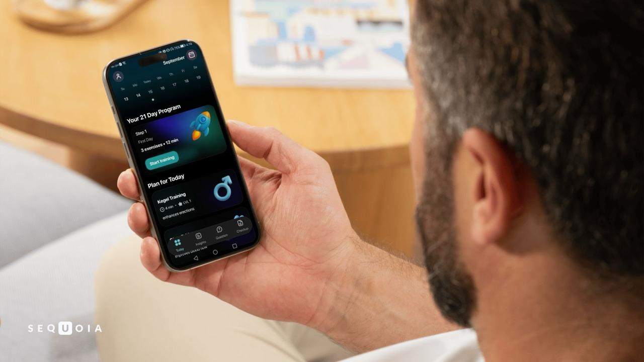 Man holding an Android device running Sequoia 1.0 with the main screen